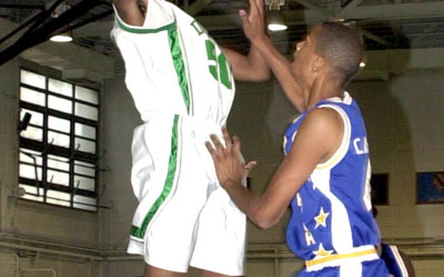 Jacorian Callier of Kubasaki goes up for a shot over Guam High&#39;s 6-foot-6 Curtis Washington.