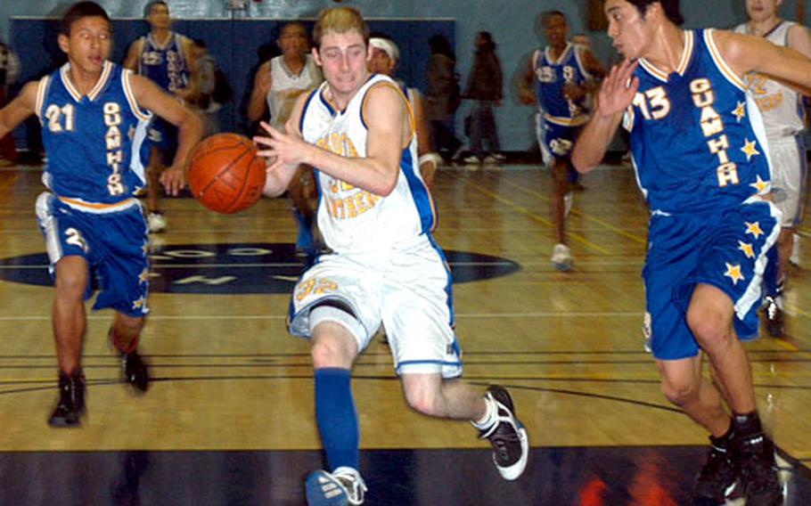 Yokota guard Peter Weaver rushes past defenders from Guam High School.