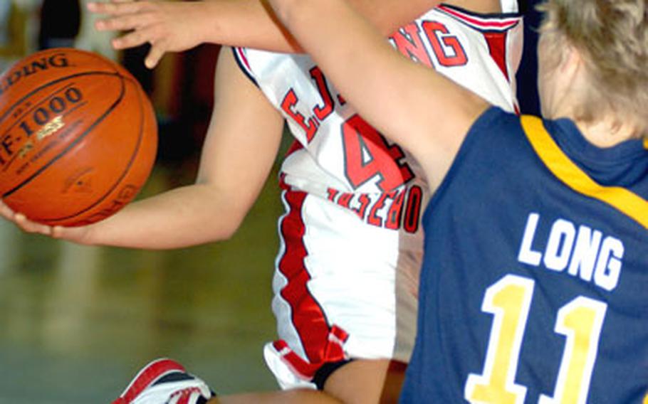 E.J. King guard Kristia Suriben shoots as Janel Long of Faith Academy defends during Tuesday&#39;s Class A game at Camp Walker, South Korea.