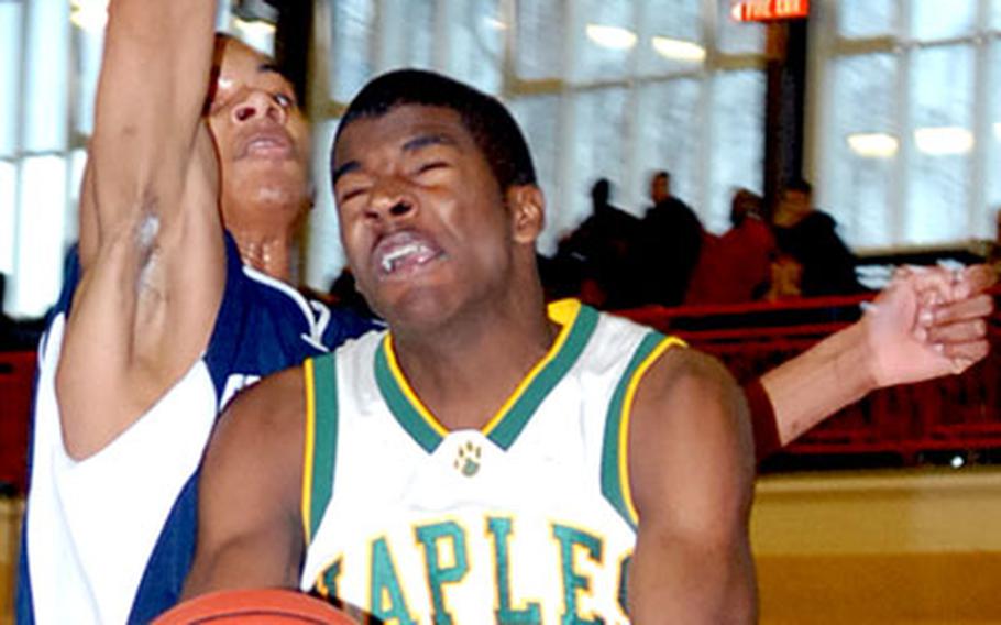 T.J. Lumar of Naples goes to the hoop against Bitburg&#39;s Mario Shanks in opening-day action at the DODDS-Europe basketball finals in Mannheim on Wednesday. Naples won the Division II game, 55-42.