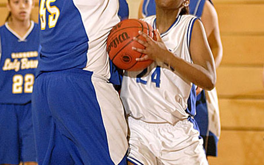 Reliesha Burns, a senior from Brussels High School, leans into Bamberg&#39;s Belinda Zapata during Brussels 43-20 win a semifinal game in the DODDS-Europe Division IV tournament on Thursday. Brussels, which had only six players, will face Lajes in Friday&#39;s final. Burns was the game&#39;s high scorer with 15 points.