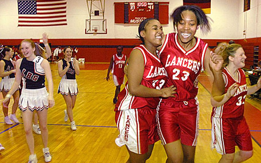 Erica Turner, left, and Angelia Gafford from Lakenheath High School celebrate their 41-37 victory over Kaiserslautern during their Division I game at the DODDS-Europe basketball championships Thursday at Mannheim. The win, however, was not enough to get the Lancers into the semifinals.