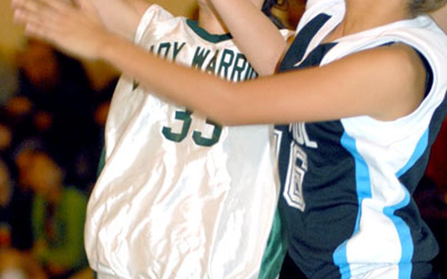 Taegu American freshman guard Sarah Eades shoots as Lani Manalo of St. Paul Christian defends during Thursday&#39;s game.