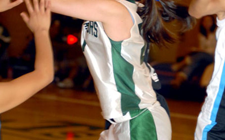 Taegu American sophomore center Ashley Smith rebounds against St. Paul Christian of Guam during Thursday&#39;s Class A game at Camp George, South Korea. St. Paul eliminated defending champion Taegu American 57-43.