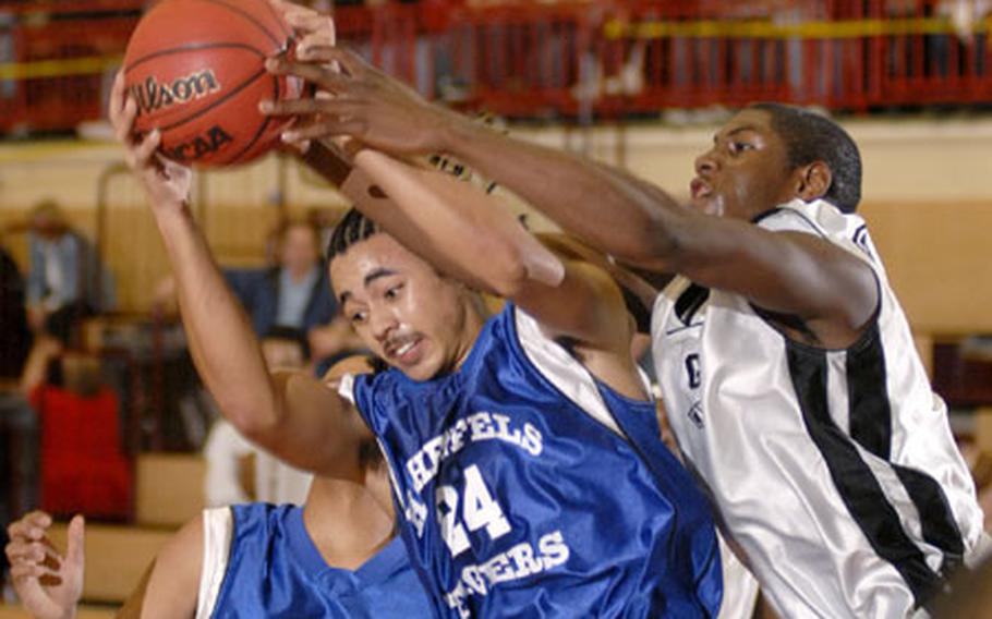 Hohenfes' Mike Tillberg battles Rico Rawls of Giessen for a rebound during the Division III championship game Saturday at Mannheim, Germany. Giessen, the reigning Division IV champs, clinched the Division III championship game by beating Hohenfel 77-57.