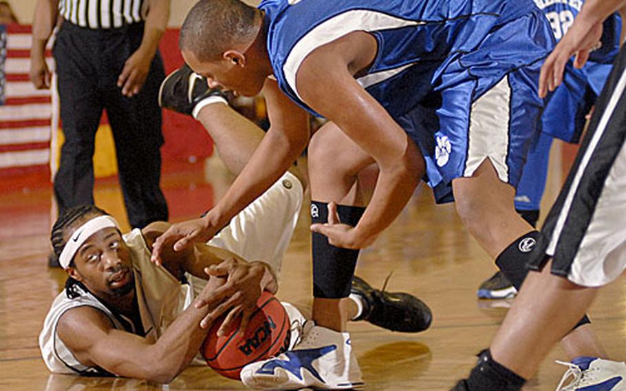 Lester Banks, a Giessen senior on the floor, and Marcus Gaddy from Hohenfel fight for possession of the ball during the second period .