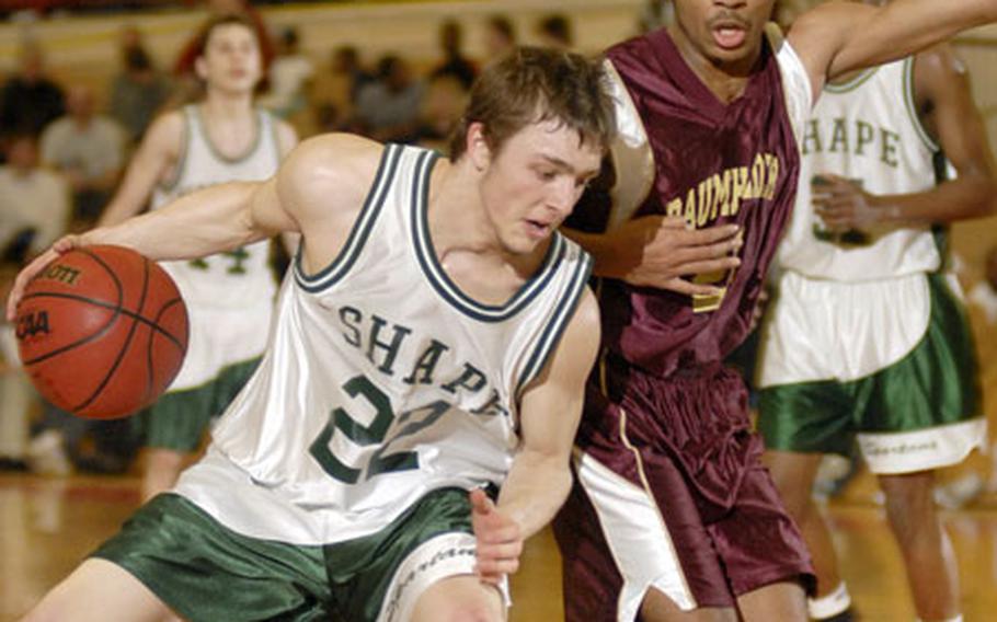 SHAPE's Kael Richardson leans into Baumholder defender Tyriek Bayne during the third period of their Division II boys championship game Saturday in Mannheim.