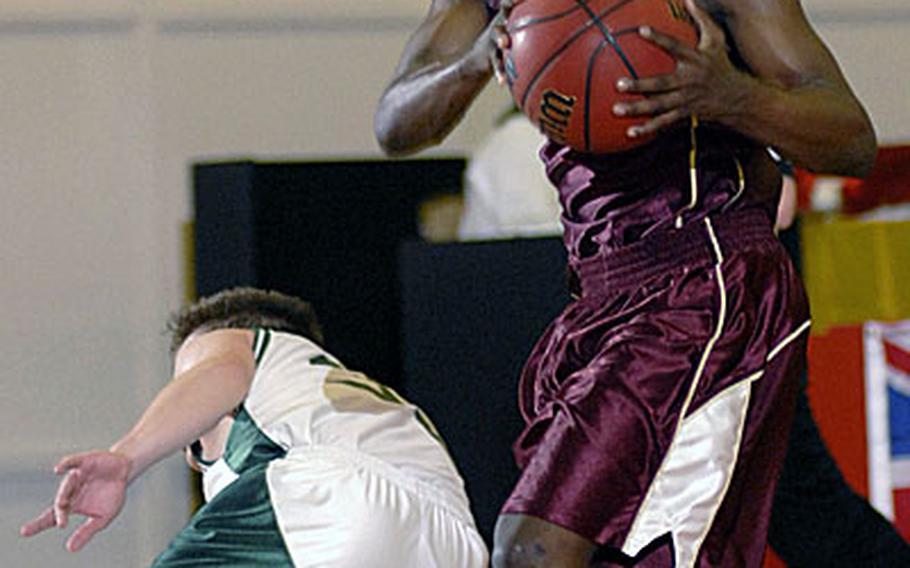 Baumholder senior Sonny Clark fakes out a SHAPE player as he drives to the basket during the second period of Baumholder&#39;s 45-39 win.