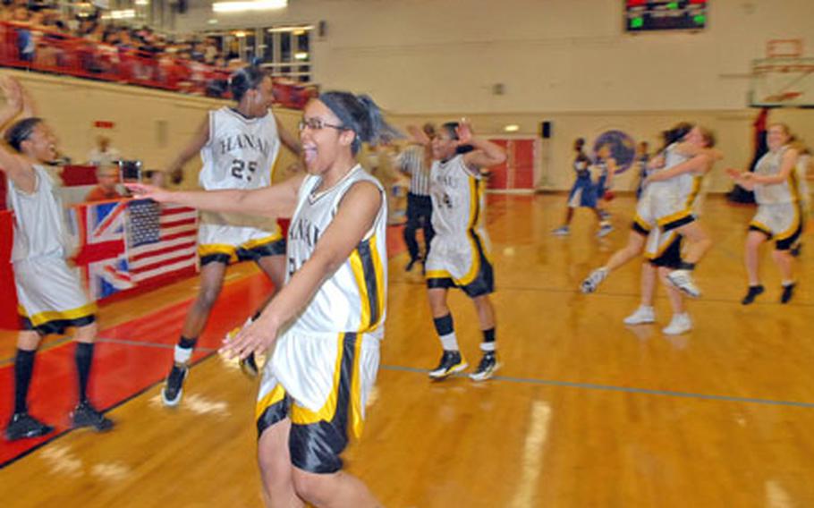 Jehan Bostick, foreground, and her Hanau Panthers teammates celebrate their 29-28 win over Rota in the Division III girls championship game at the DODDS-Europe basketball finals in Mannheim, Germany, on Saturday.