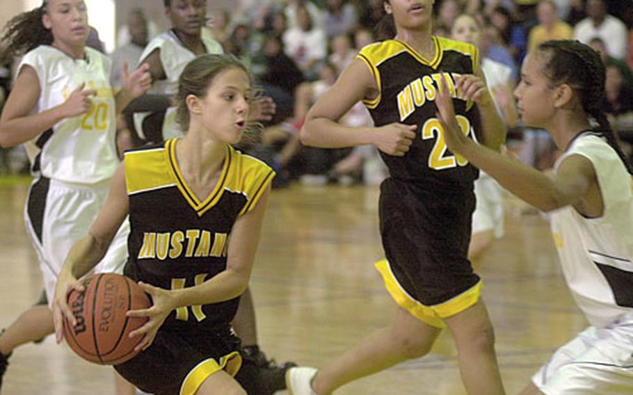 American School in Japan Mustang sophomore forward Gwen Thornton, #11, puts on the brakes as Kadena High School Lady Panther frosh forward Aja Walker, #33, steps in to block her path during the final game of the Far East High School Girls Class AA Basketball Tournament in the Kadena High School gym on Saturday. The Lady Panthers won the game 85-32.