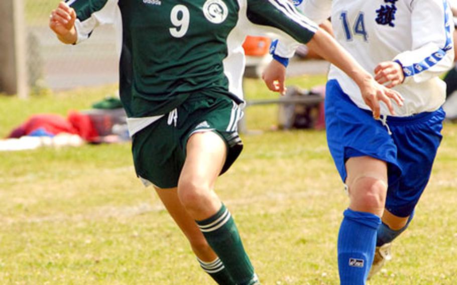 Rina Ihu (9) of the Kubasaki Dragons outruns Arisa Taira of Nago High School for the ball during Saturday's girls high school soccer match at Upper Field, Kubasaki High School, Camp Foster, Okinawa. The Dragons outlasted a late second-half rally to edge Nago 3-2.