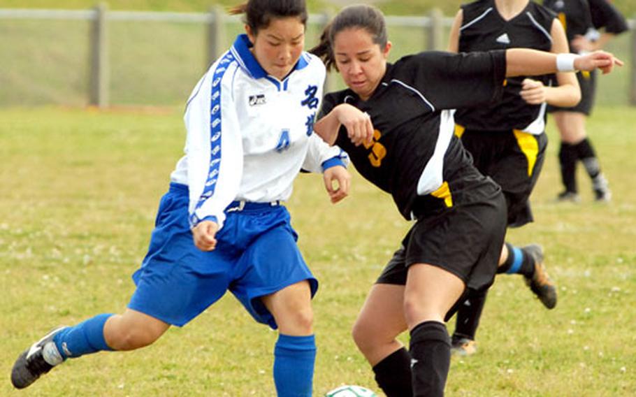 Minami Nakahara (4) of Nago High School battles Pacific single-season goal scoring record-holder Jen Abel of Kadena (3) for the ball during Saturday&#39;s game. Abel scored twice and assisted on the third goal as Kadena downed Nago 3-1.