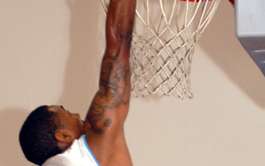 Kadena Falcons guard Markell Felder skies above the rim for a slam dunk against South Korea&#39;s Osan Defenders.