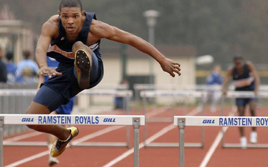 Romonno Washington, an junior from Heidelberg High School, clears the final hurdle on his way to winning the 300- meter low hurdles with a time of 45.94 seconds at a track meet at Ramstein High School on Saturday.