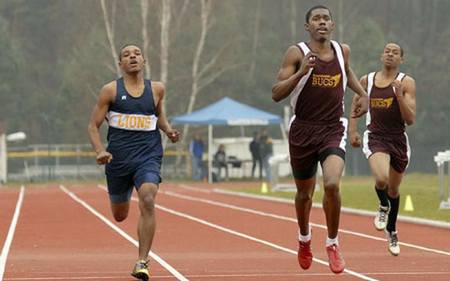 True Davis, center, a senior from Baumholder High School, sprints to victory in the 400-meter dash Saturday at Ramstein. He finished in 54.16 seconds.