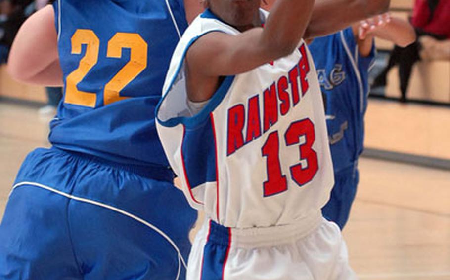 Ramstein's Cheryl Burney, right, pulls down a rebound in front of Wiesbaden's Atesha Potter in the women's final of the Army-Air Force Final Four in Wiesbaden, Germany, on Sunday.