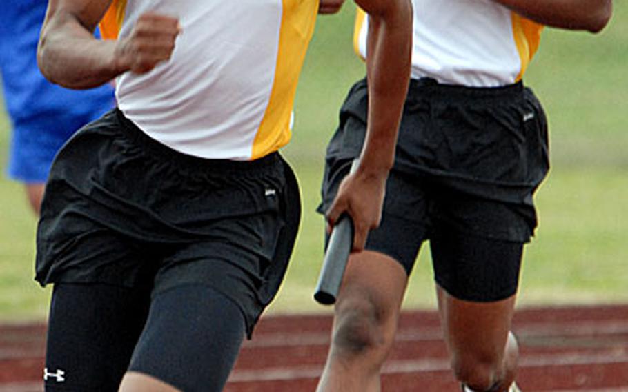 Kadena Panthers senior Manuel Duran takes the handoff from J.R. Wright and pounds for home during the 400-meter relay in the 5th Alva W. "Mike" Petty Memorial Track and Field Meet at Mike Petty Stadium, Kubasaki High School, Camp Foster, Okinawa. Kadena won the event in meet-record time, 45.28 seconds, beating their own mark of 45.84 set last year.