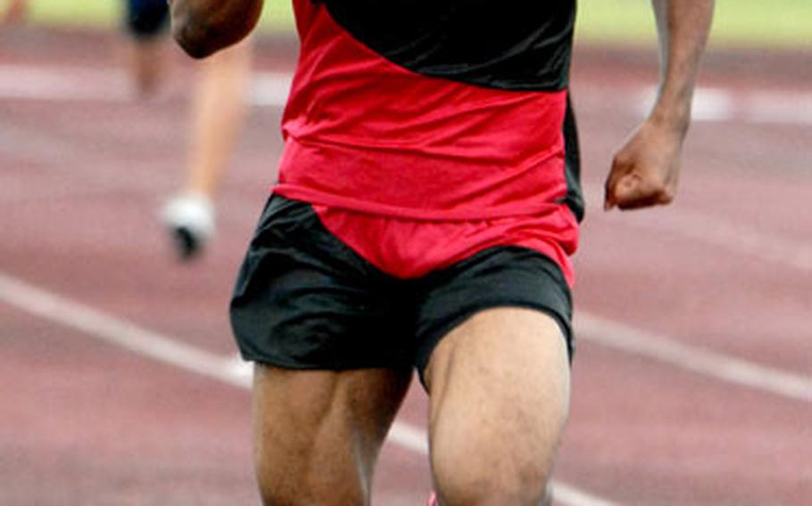 Seoul American High School senior David Smalls runs the anchor leg of the 1,600-meter relay in the Petty Memorial Track and Field Meet on Okinawa.