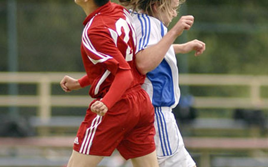 Michael Soto, left, of Kaiserslautern and Dab Whitney of Ramstein collide while battling for the ball during the second half of Ramstein&#39;s 3-0 win.