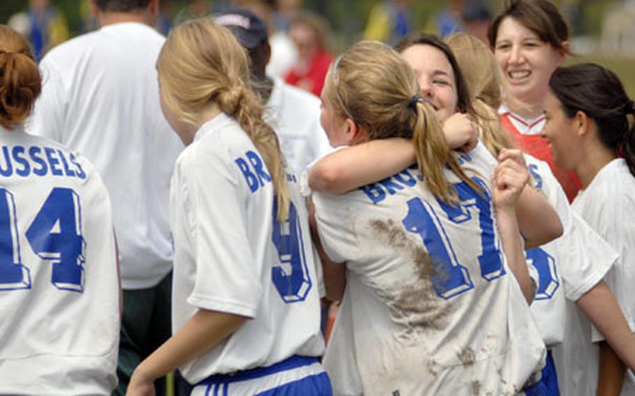 Marie Reimann gives Marlena Schlattmann a hug after Brussels High School won the girls Division IV title in the DODDS-Europe soccer championship tournament on Friday. Brussels beat Alconbury 5-1, for its second-straight crown. Schlattmann scored twice during the championship game.