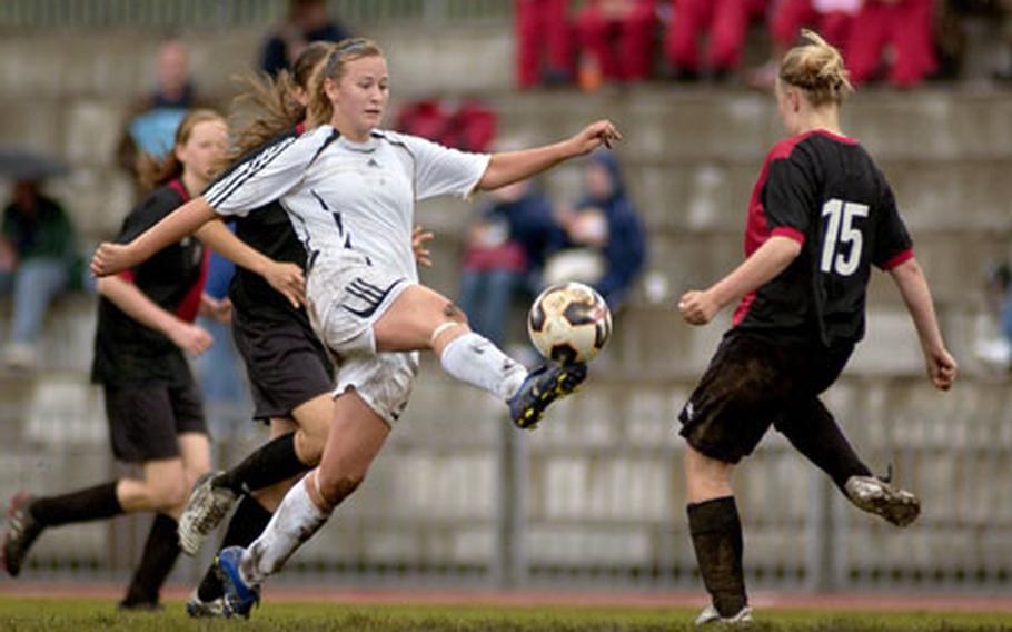 Macy Jepsen, a sophomore at Ramstein High School, snakes the ball past Susana Paardekooper, a sophomore from the International School of Brussels, Thursday during their semifinal game in the girls DODDS-Europe Division I soccer tournament. Jepsen led her team with two goals and one assist in a 4-0 shutout again ISB.