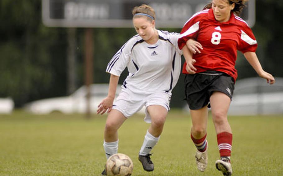 Alana Sciuto, a Ramstein freshman, locks up with Kaitline Hines of Kaiserslautern while battling for teh ball in the championship game of the DODDS-Europe girls Division I soccer tournament on Friday. Ramstein won 3-0.