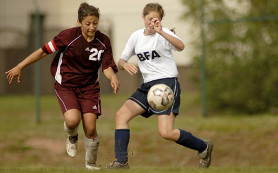 Cathy DelaRosa, a Vilseck senior, pushes the ball past Cameron Prenger from Black Forest Acadmey during their DODDS-Europe Division II soccer tournament championship game Saturday at Ramstein. Vilseck defeated BFA 2-0.