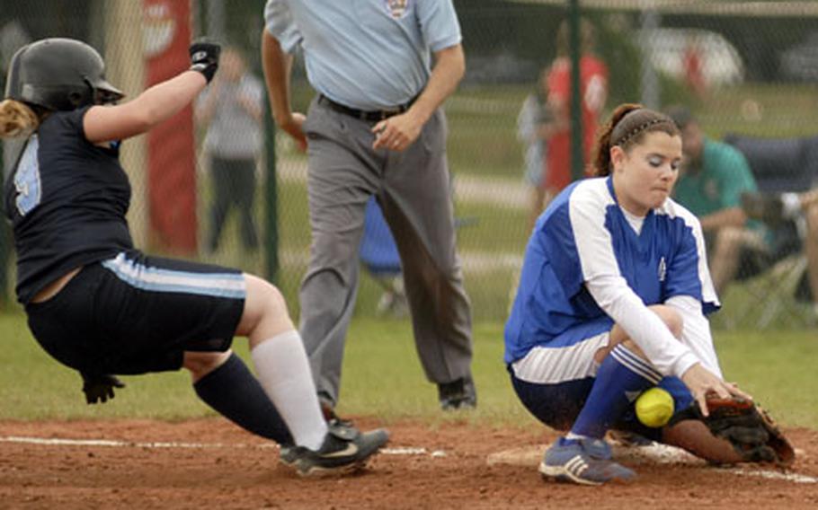 Alaina Koonst, a sophomore from Incirlik, slides back to first base as Sara Sheffield from Rota tries to gather the ball during their DODDS-Europe Small Schools softball championship match-up Saturday at Ramstein. Rota defeated Incirlik 15-4 in the five-inning game ended by the courtesy rule.