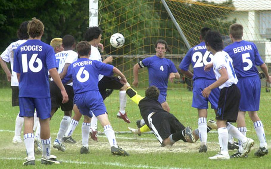 Guam High School goalie Tyler Thomason, a junior, and teammate Allen Moos (4), try in vain to block the fourth goal by Seoul American High School in the final 45 seconds of Tuesday&#39;s game.