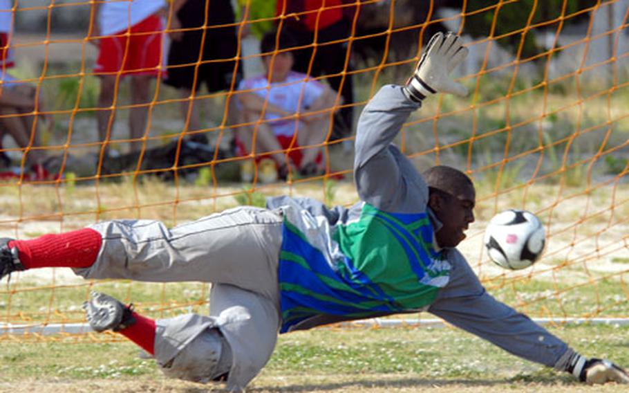 E.J. King goalkeeper Demond Dean can&#39;t stop an Indianhead International Wolverines try in the penalty-kick shootout, but the Cobras won the shootout, 5-4, and the match, 2-1.