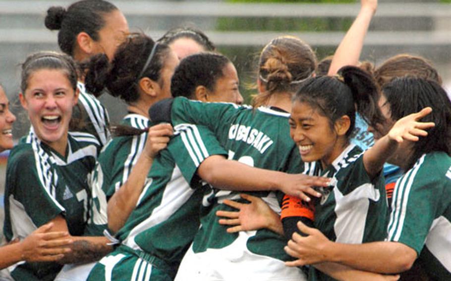 Kubasaki Dragons girls soccer players celebrate Friday&#39;s 2-1 championship victory over Nile C. Kinnick in the 2007 Far East High School Class AA Tournament.