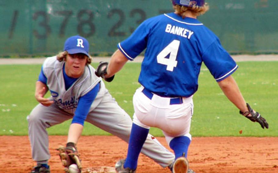 Ramstein Rhinos shortstop Kyle Sanders prepares to tag out Rota&#39;s Andrew Bankey on an attempted steal of second base Sunday during Rota&#39;s 4-0 title-game victory in the Installation Management Command-Europe&#39;s baseball tournament for high school-aged players.