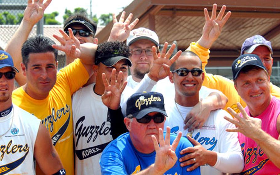 From left, Jon Nicholson, Elmer Mason, Mike Ladd, Greg Zayas, Billy Laxton, coach Tom Costello (blue shirt), Jimmy Perez, Jeff Libengood and Tony "Ice" Iafelice hold up four fingers to celebrate Monday&#39;s fourth straight men&#39;s championship in the 2007 Pacificwide Open Softball Tournament. Guzzlers beat their brother team, Los Guzzleros, 25-6 in three innings.