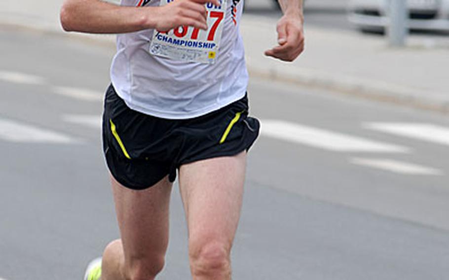 Army Capt. John Dreher runs down the final stretch to victory in the IMCOM-Europe U.S. Forces 10-Miler at Grafenwohr.