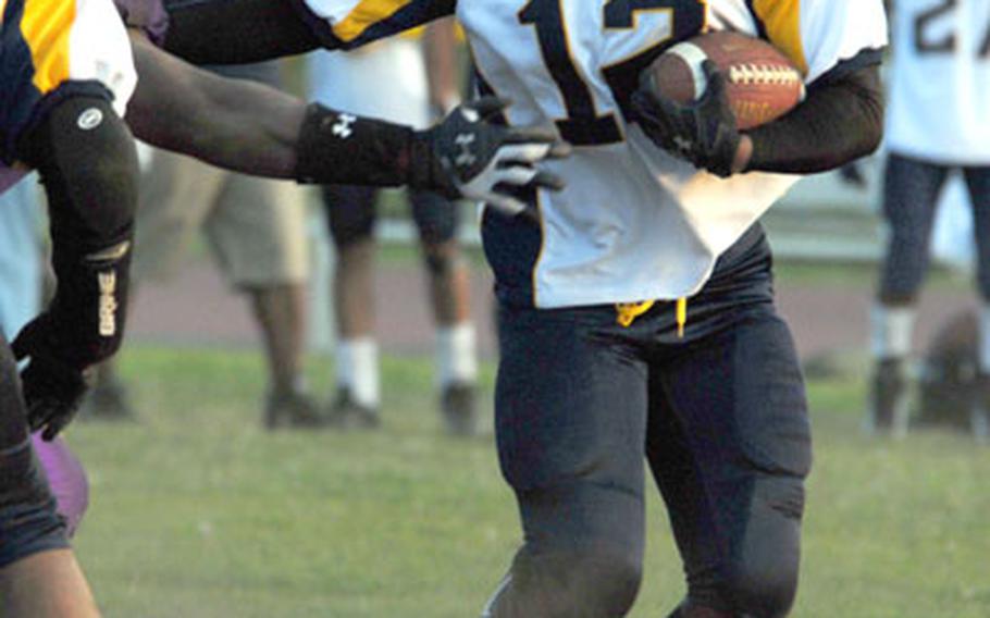Yokota Warriors running back Terrence Nash (12) rounds left end on a sweep against the Misawa Jets during Saturday&#39;s U.S. Forces Japan-American Football League season-opening game. Yokota beat Misawa 16-6.