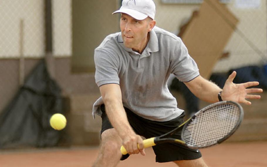 Spc. Jamie Rydell, a soldier from the 106th Financial Management Company out of Bamberg, meets the ball during the second set of his U. S. Forces Europe Tennis Championship game against Roy Tannis of Darmstadt at Heidelberg.
