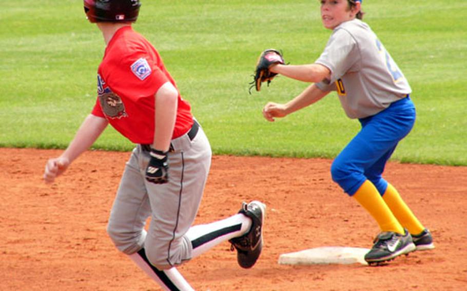 London shortstop Brett Fitzpatrick chases Ryan Tannenbaum back toward first on a double-steal attempt Friday during Stuttgart-Wiesbaden’s 9-8 victory in Little League Baseball’s Transatlantic Regional in Kutno, Poland. Tannenbaum was eventually tagged out on the play, but not before Dylan Measells raced home from third for his team’s third run of the inning and a 7-5 Bulldog lead.