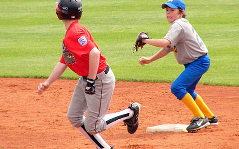 London shortstop Brett Fitzpatrick chases Ryan Tannenbaum back toward first on a double-steal attempt Friday during Stuttgart-Wiesbaden’s 9-8 victory in Little League Baseball’s Transatlantic Regional in Kutno, Poland. Tannenbaum was eventually tagged out on the play, but not before Dylan Measells raced home from third for his team’s third run of the inning and a 7-5 Bulldog lead.