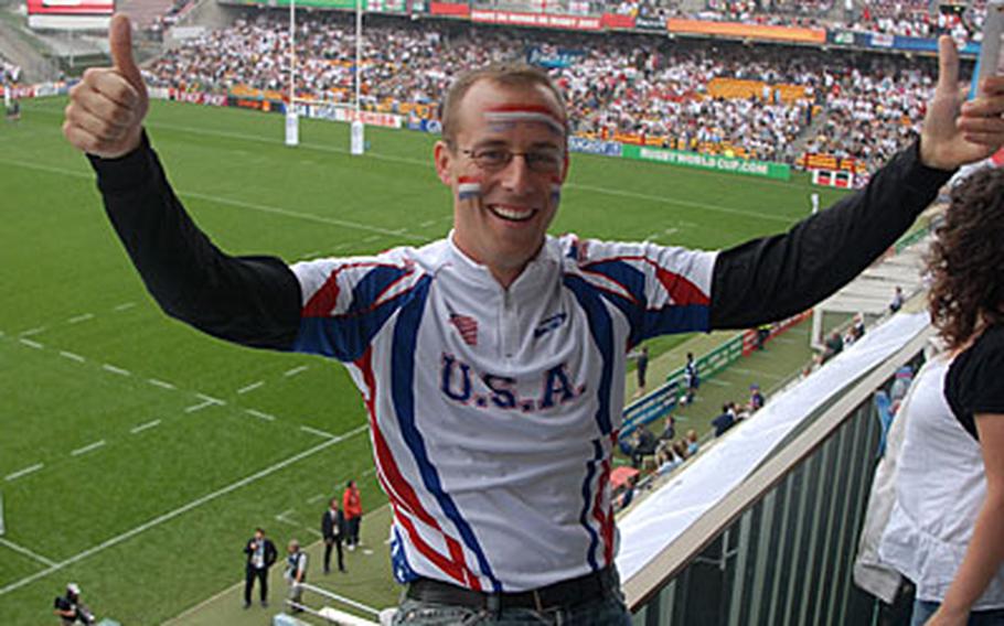 U.S. Eagles supporter Brian Lang, of New York, wearing a red, white and blue shirt and face paint, stands out from others in the crowd at a Rugby World Cup match at Lens, France.