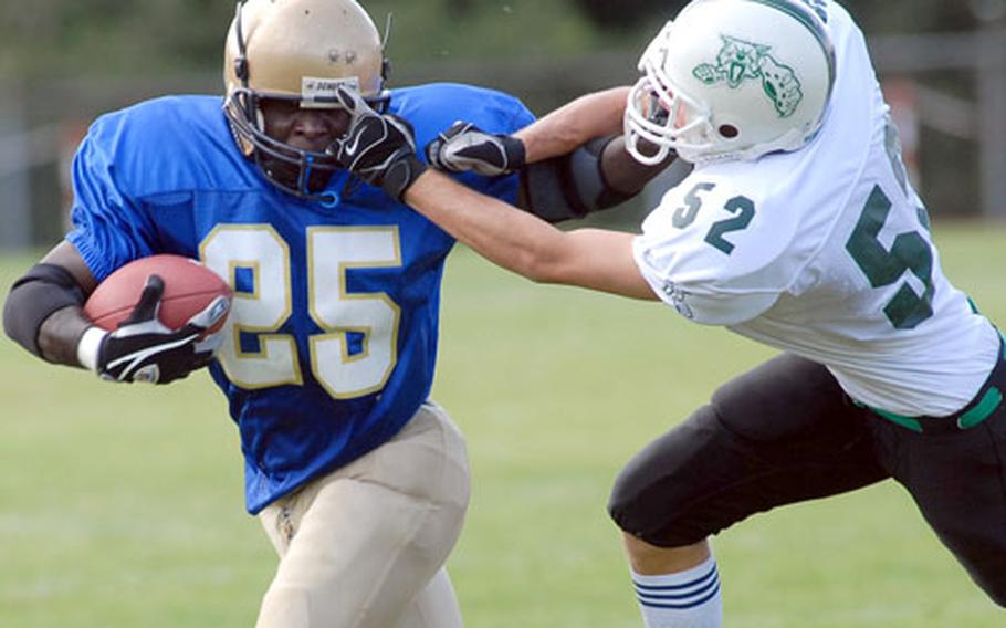 Wiesbaden&#39;s Ron Peebles, left, tries to keep Naples Wildcat Peter Lawton at arms length as he picks up yardage in an opening day game of the 2007 DODDS-Europe football season. Naples beat Wiesbaden, 31-29, in an exciting, non-conference Division II matchup.