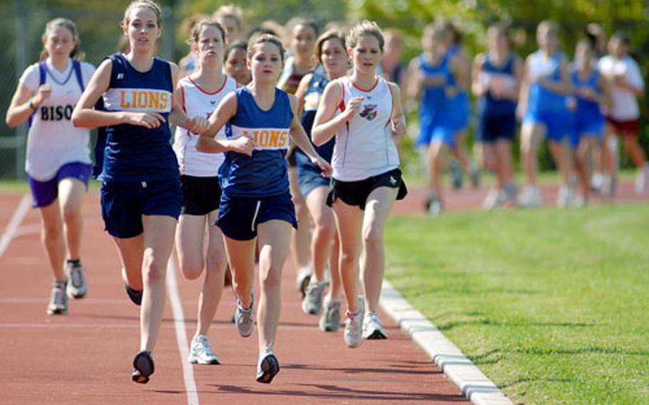 Heidelberg's Julie Caldwell, second from left, leads the runners off into a new cross country season in Wiesbaden on Saturday. Caldwell won the race in 22 minutes, 40 seconds ahead of teammate Lauren Brousseau and Alison Ochoa of Wiesbaden. Heidelberg won the girls team comeptition, with Wiesbaden second and Baumholder third.