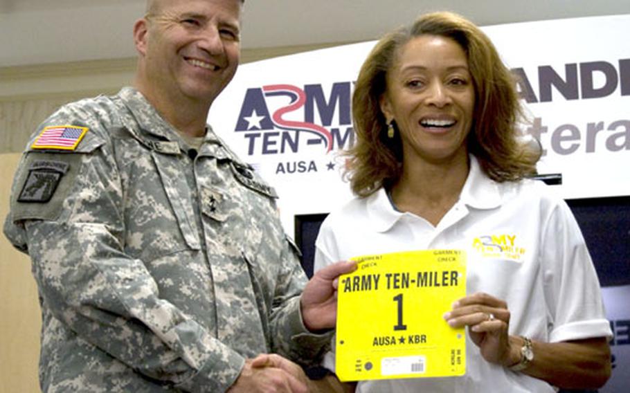 Alisa Harvey receives her competitor&#39;s number from Maj. Gen. Richard J. Rowe, Jr., commanding general of the Military District of Washington.