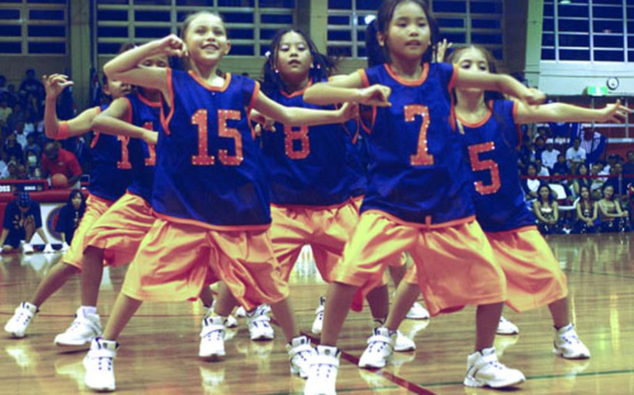 Members of T-Da, a hip-hop dance team of youngsters of American-Japanese descent on Okinawa, perform at halftime of Saturday&#39;s game.