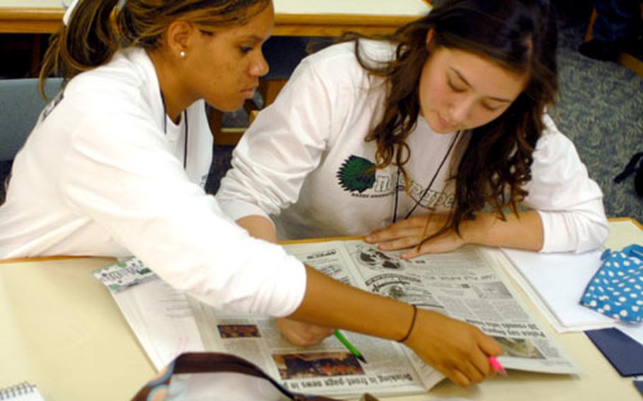 Taegu American newspaper teammates Ann Kimble and Ashley Smith look over news articles as part of Monday&#39;s news writing session during the 2007 DODDS-Pacific Far East journalism conference. Smith also plays volleyball, and missed practice time with her team this week, but said having so many activities choices helps lend to the diversity that is DODDS-Pacific&#39;s hallmark.