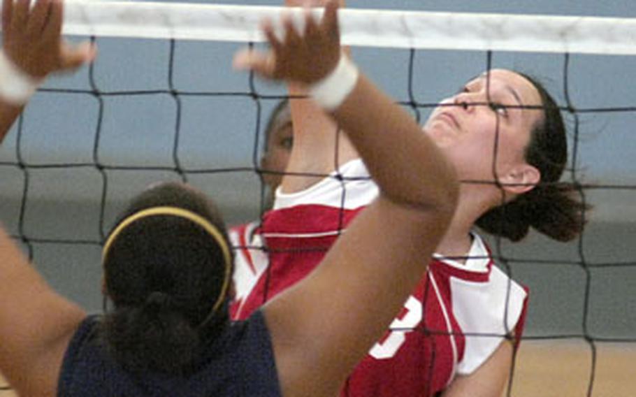 Lisa Domingo, a senior at Kaisterslautern High School, spikes over Courtney Milton of Heidelberg. Kaiserslautern beat Heidelberg 25-10, 25-23, 18-25, 26-24.