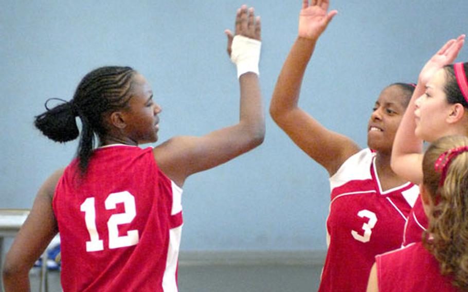 Tylisa Hendrix, a sophomore at Kaisterslautern High School, celebrates a big play with senior Deadre Green and teammates.