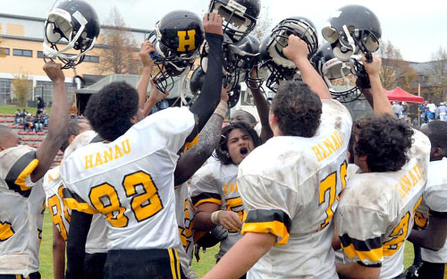 The Hanau Panthers celebrate their Division IV title in the school&#39;s final game after beating Menwith Hill 58-20.