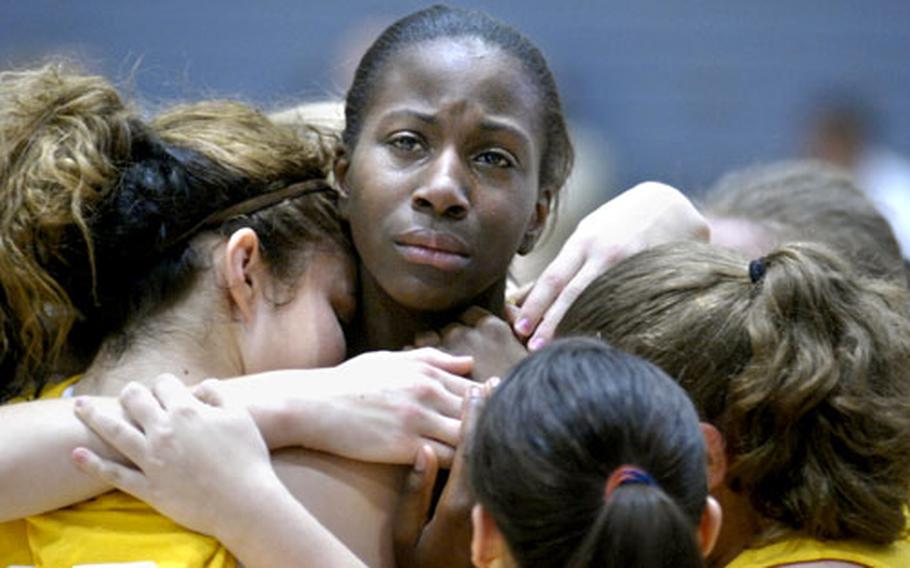 Dontaya Powers, a freshman from Baumholder High School, consoles Briana Hudak and other teammates after a five-set battle with Marymount International School Saturday at Ramstein. Marymount defeated Baumholder in the Div. III championship game 25-7, 27-29, 25-11, 13-25, 15-4.