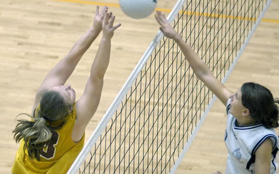 Elena Carrarino of Marymount International School meets Katrina Alsup of Baumholder at the net Saturday at Ramstein. Marymount defeated Baumholder in the Div. III championship game 25-7, 27-29, 25-11, 13-25, 15-4.