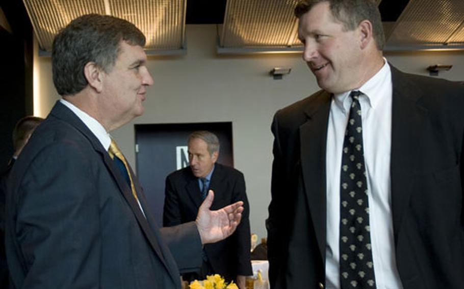 Coaches Paul Johnson of Navy, left, and Stan Brock of Army chat during the recent Army-Navy game media day at Baltimore.